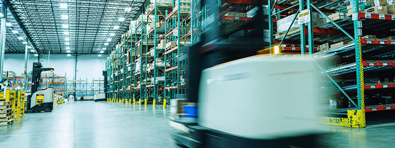 Forklift moving quickly through an Endries warehouse