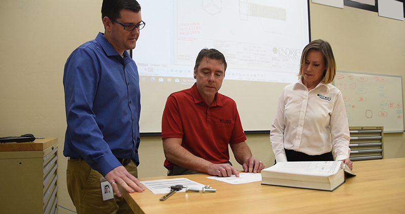 Engineering lab with three employees